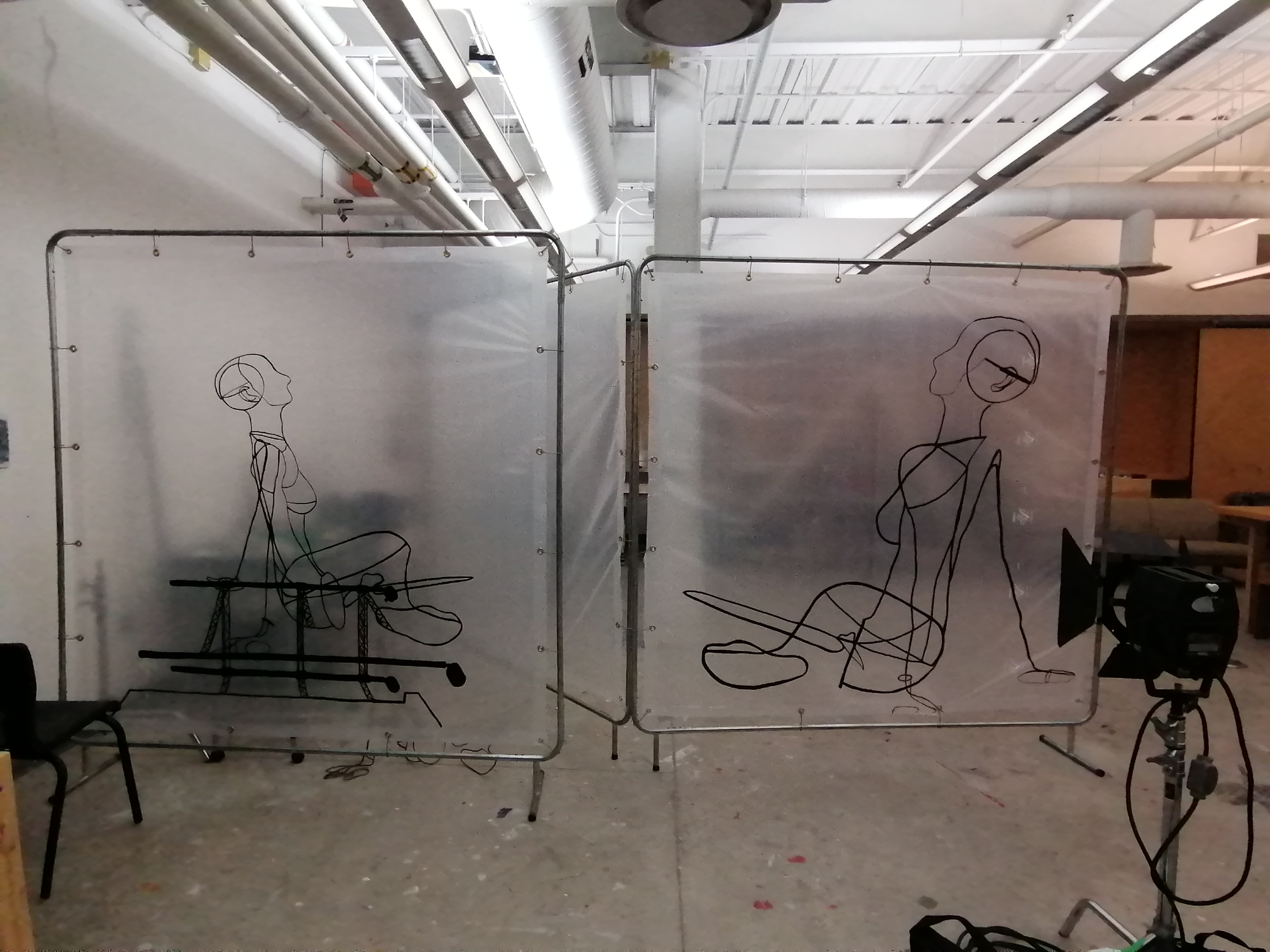 an artwork by Ada Denil consisting of translucent welding screens with line drawings